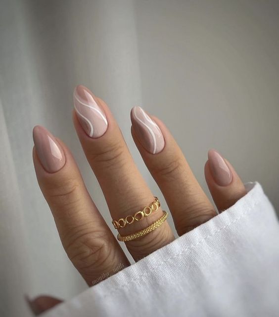 a cool nude manicure with two accent swirl nails done wiht white and light pink is amazing for spring or summer