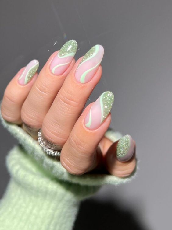 a cool spring manicure with mint green and glitter swirls is a lovely idea for a girlish and cute look in spring