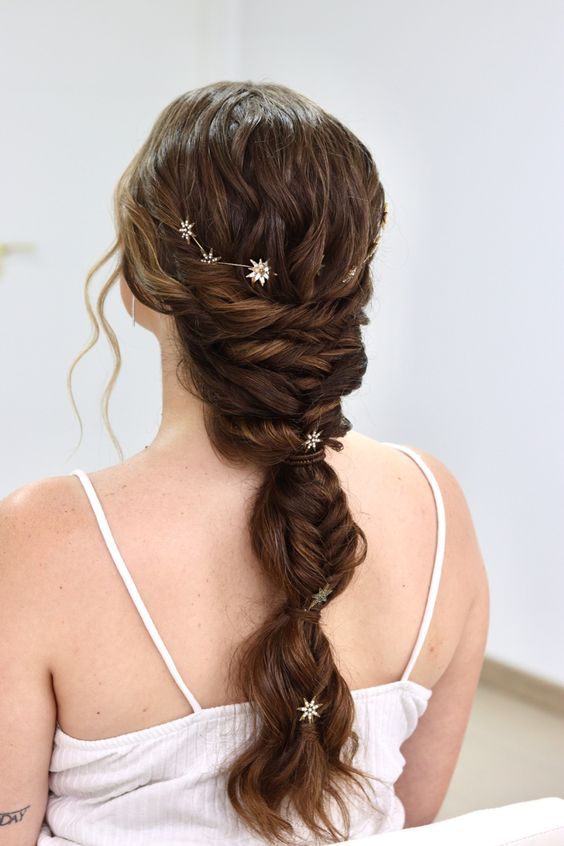a creative wedding braid with twists and ponytail touches, a celestial vine and some star hair pins is wow