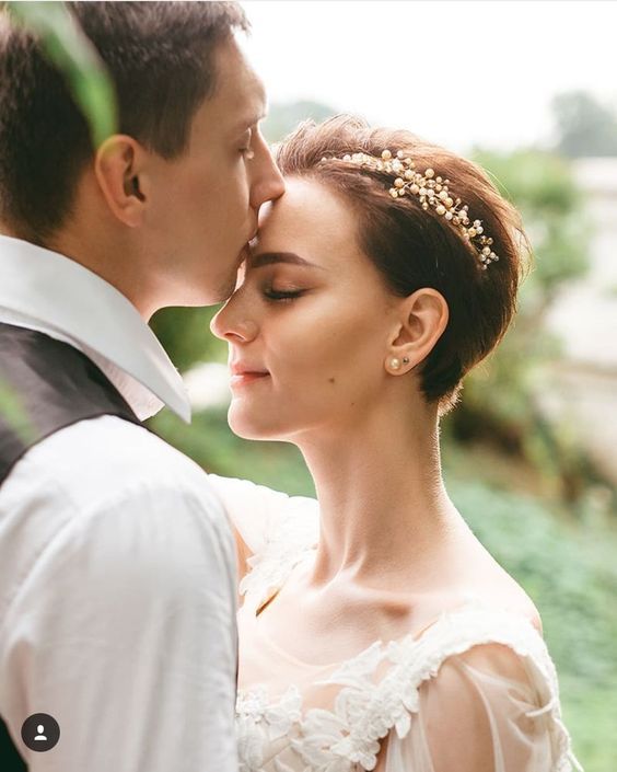 a dark brunette pixie cut with a pearl hair piece is a cool and catchy idea for a modern bridal look