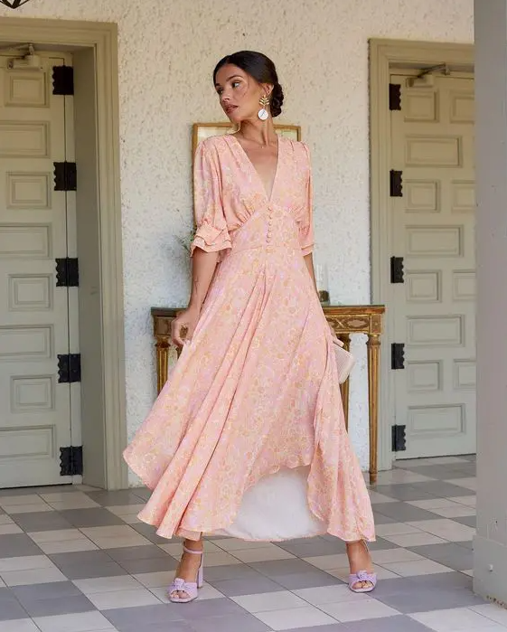 a delicate blush floral maxi dress with short sleeves, buttons, lilac shoes and statement earrings for a spring bridal shower
