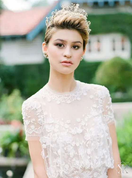 a dimensional pixie haircut with caramel balayage and a rhinestone tiara is a gorgeous and chic idea for a wedding