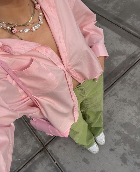 a fun Easter look with a pink button down, green corduroy pants, white sneakers, layered necklaces