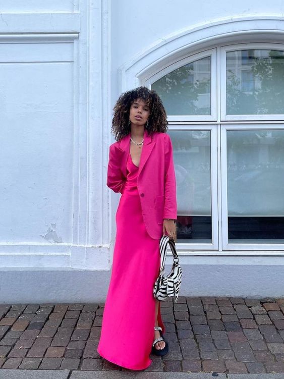 a hot pink ensemble of a maxi slip dress and a blazer, embellished shoes and a zebra print bag is wow