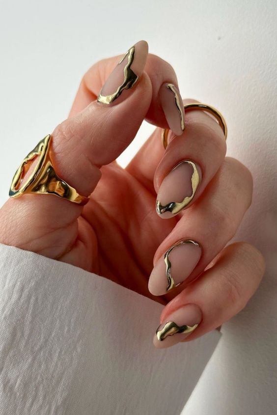 A jaw dropping matte nude plus gold foil swirl manicure is a fantastic idea for a glam look or for NYE
