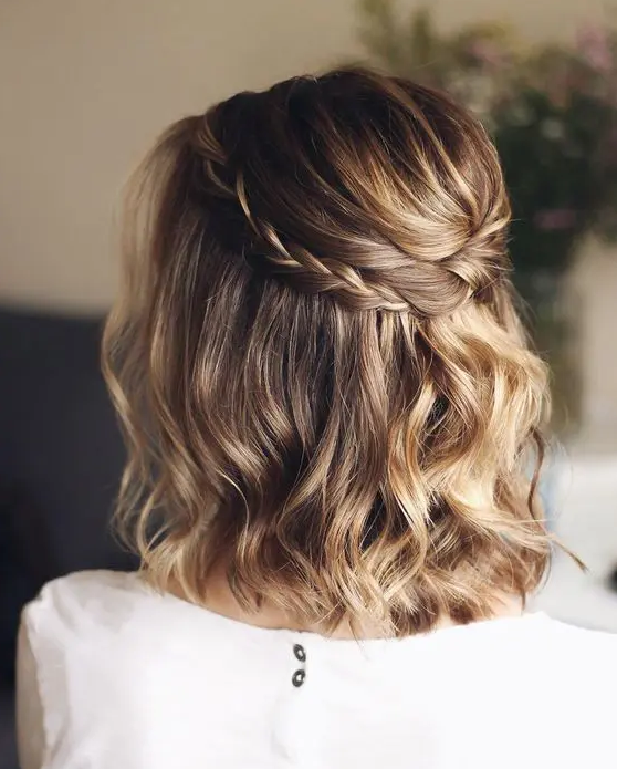 a light brown long bob with gold blonde balayage, waves and a braided halo is a chic and stylish idea for a wedding