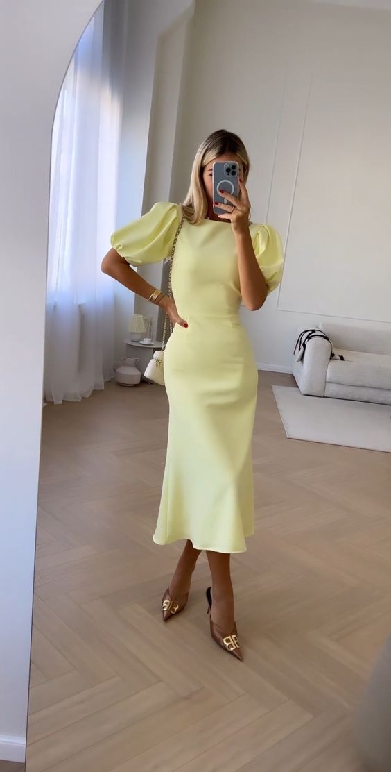 a light yellow midi dress with puff sleeves, brown embellished shoes and a white bag are a cool look for a spring wedding or bridal shower