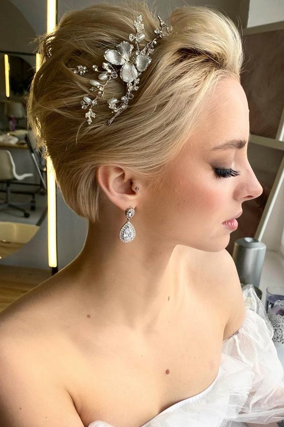 a long blonde pixie styled back and adorned with a pearl and flower hair vine is amazing for a wedding