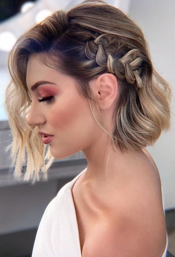 a long bob accented with a single loose side braid and waves is a cool and modern solution for a wedding