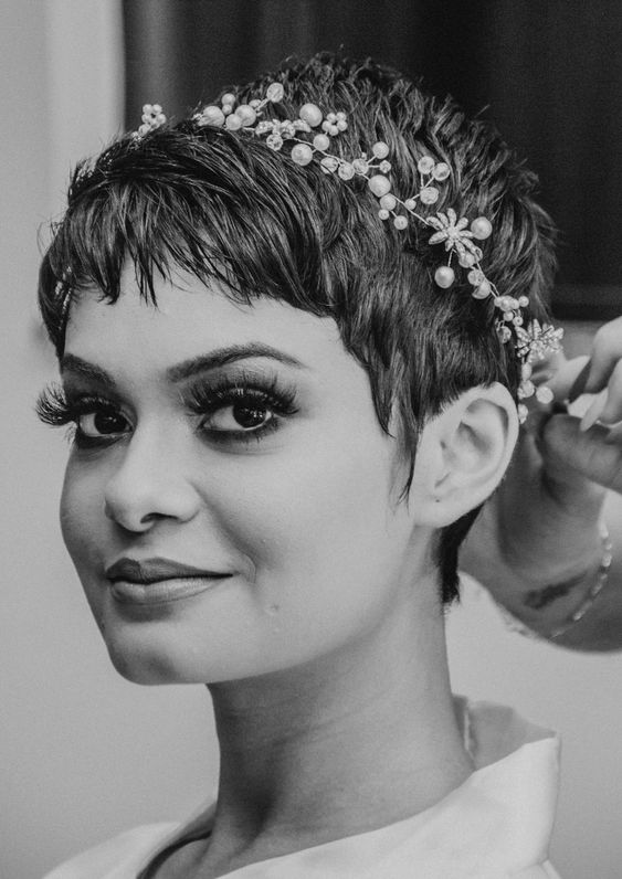 a long pixie haircut with a bit of messy volume and a pearl and rhinestone hiar vine is amazing for a wedding
