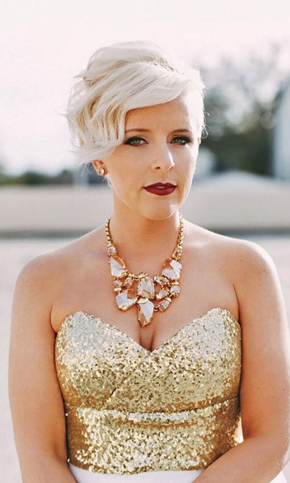 a long platinum blonde pixie cut with a lot of volume and wavy bangs is amazing for a glam wedding
