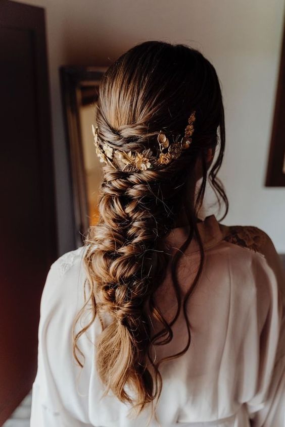 a loose twisted braid with twisted halos and some hair down, a gold hair vine are a lovely combo for a wedding