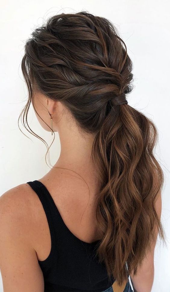 a lovely girlish wavy low ponytail with a very wavy top and some face-framing hair is a very chic hairstyle to try