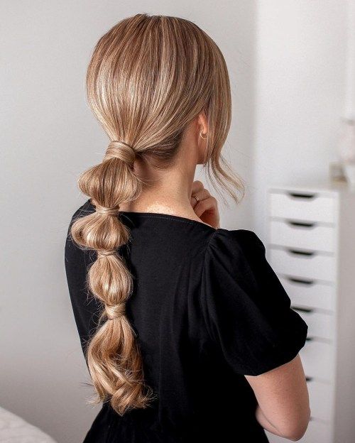 A low bubble ponytail with a sleek top and face framing hair is a cool ideafor a more casual bridal look