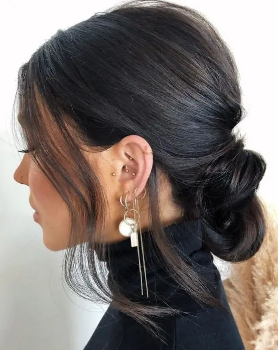 a low knot with a bump on top and some hair framing the face is a catchy and lovely idea for everyone