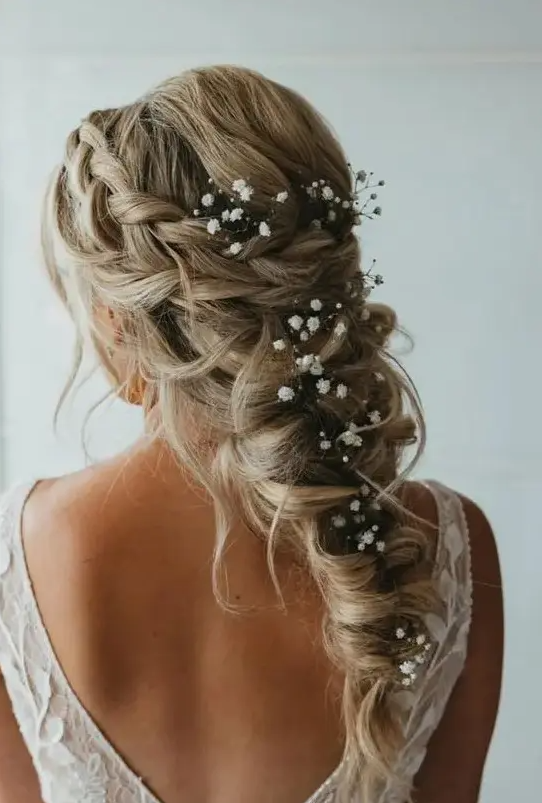 a mermaid braid with a braided halo and some baby’s breath tucked in, it’s a cool idea for a spring boho bride