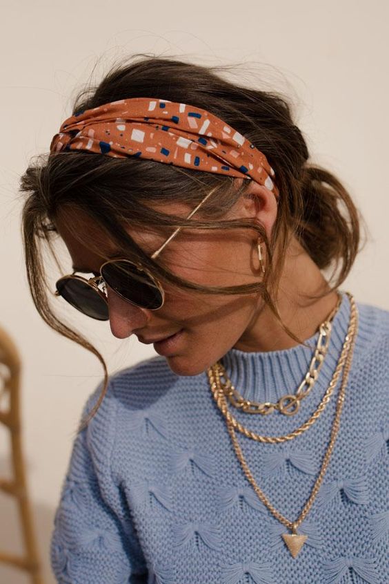 A messy low bun with face framing hair, a bold printed headband are a lovely combo for any every day look