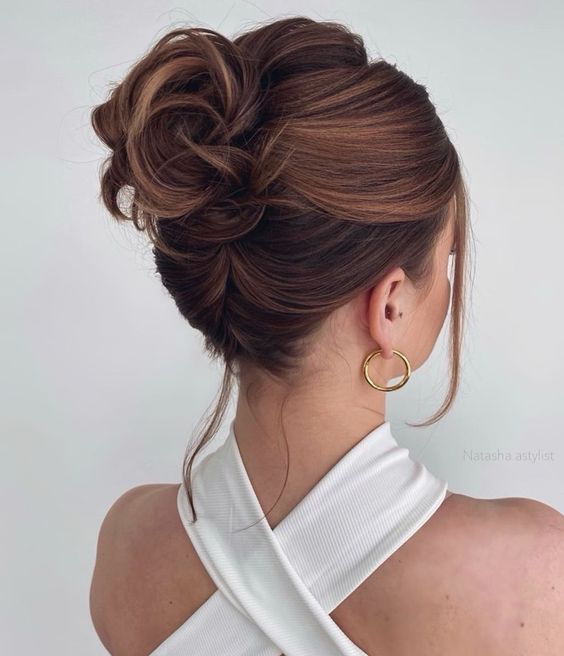 A messy wavy updo on medium hair, with a messy bump on top and some face framing hair is a cool solution