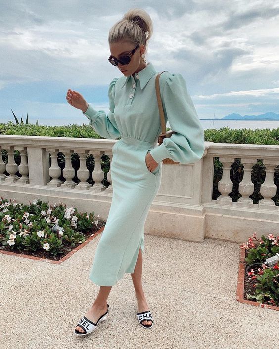 a mint blue fitting dress with puff sleeves and buttons, printed mules, a nude bag and sunglasses for a bridal shower