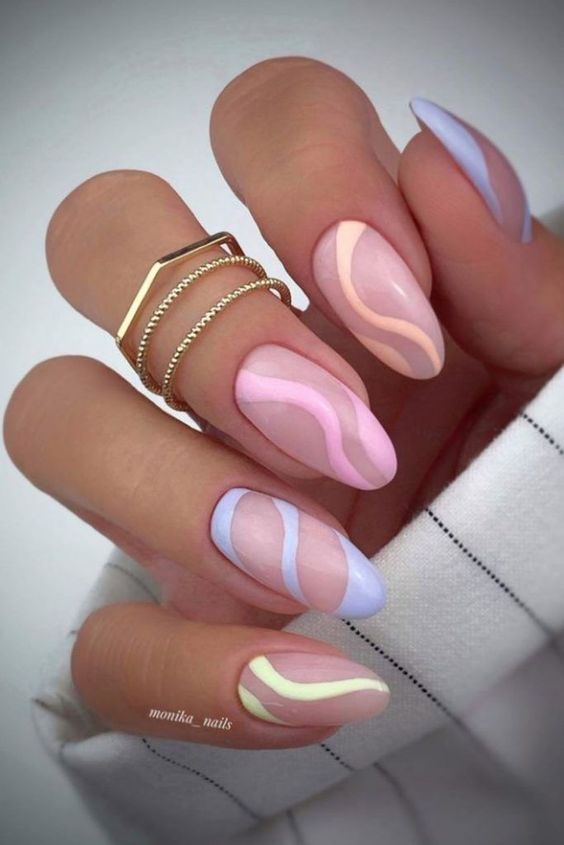 a pastel swirl nail design done with orange, pink, blue and yellow is a cool and fun idea for spring or summer