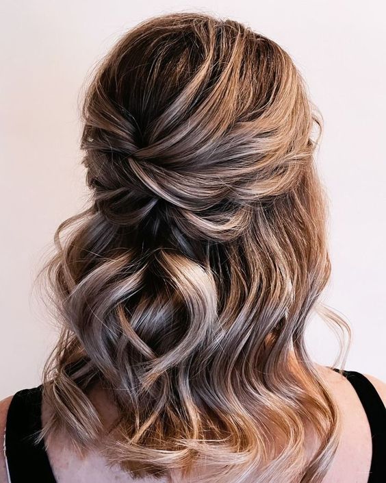 a pretty half updo with a bump on top, twists and waves down is a classic idea fro a wedding