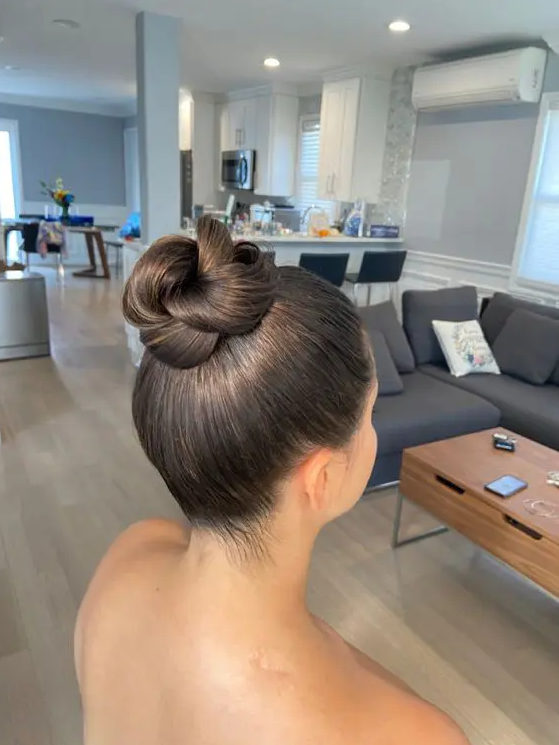 a pretty knotted bun with a sleek top is a chic and stylish solution and a fresh take on a usual bun