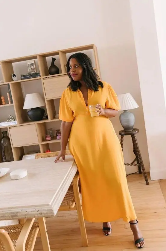 a pretty yellow maxi dress with short puff sleeves and black heeled sandals are a cool look for a bridal shower