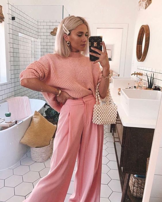 a refined Easter look with a pink oversized jumper, pink wideleg pants, a beaded bag and a pearl hair clip