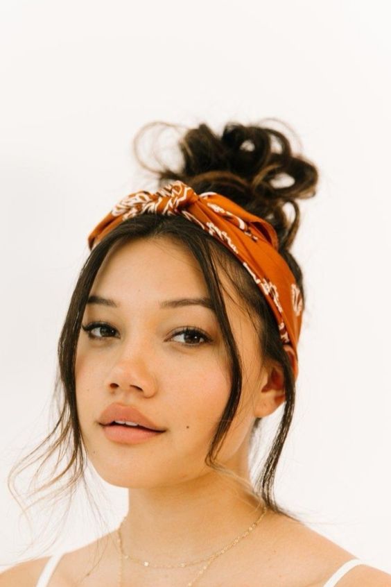 a retro look with a messy top knot, some hair down and a bold printed headband are amazing