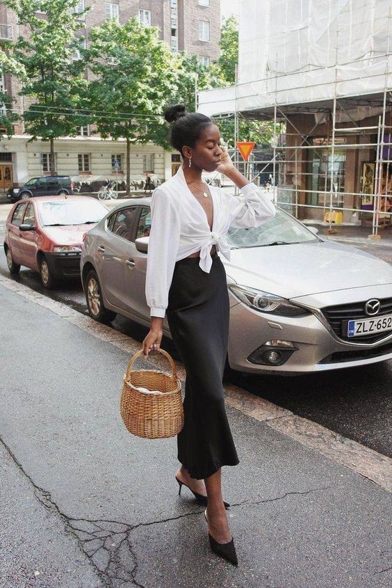 a romantic spring look with a white button down shirt, a black slip midi skirt, black heeled mules and a basket as a bag