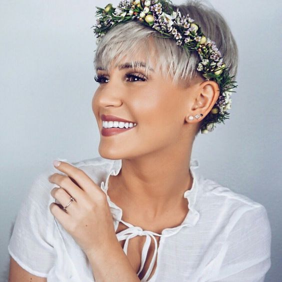 a short platinum blonde pixie cut accented with a floral crown is amazing for a bridal look
