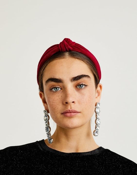 a sleek updo with a sleek top and parting, a bold red headband and statement earrings will make up a nice look for a party
