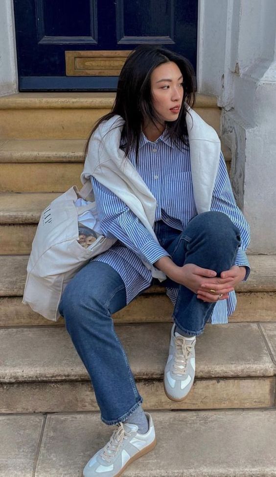 a spring look with a blue button down, a white jumper, blue jeans, neutral sneakers and a white tote bag