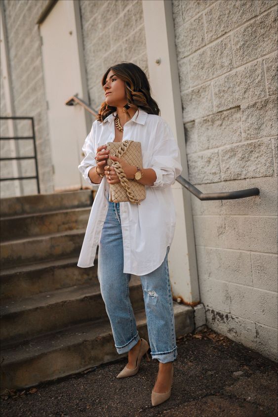 a spring look with blue jeans, an oversized button down, nude shoes and a nude bag plus a chain necklace