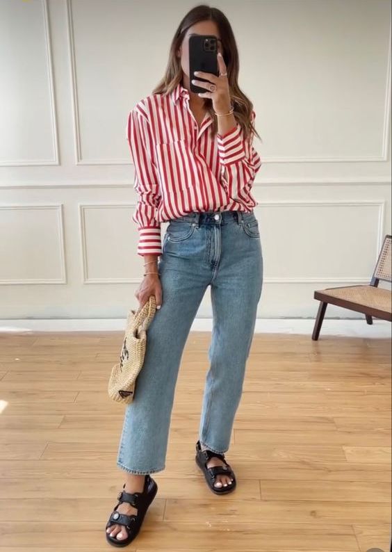 a spring to summer look with a red striped button down, blue jeans, black sandals and a woven bag