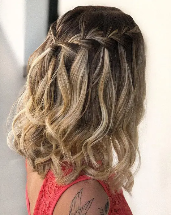 a stylish medium half updo with a braided halo and waves down is a cool boho and girlish idea