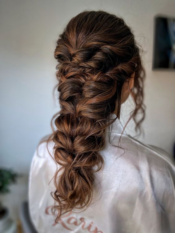 a super large and thick braid with twisted halos and hair down is a cool idea for long and thich hair