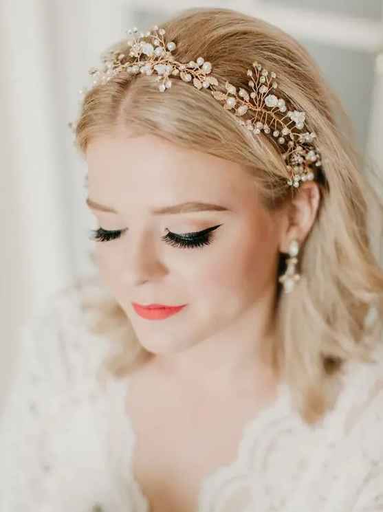 a textured golden blonde long bob with central parting and a pearl headpiece is a very romantic and cute idea for a wedding