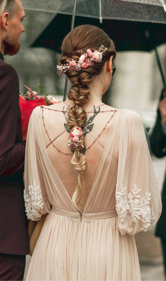 a tight twisted bubble braid with pink blooms is a cool and chic idea for a spring or summer wedding
