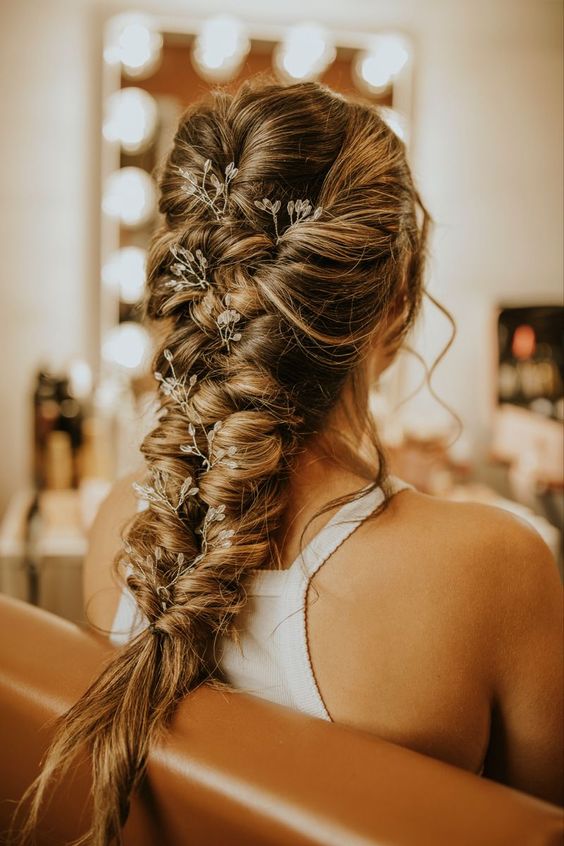 a volumetric twisted braid with a crystal hair vine is a nice rustic or boho wedding hairstyle
