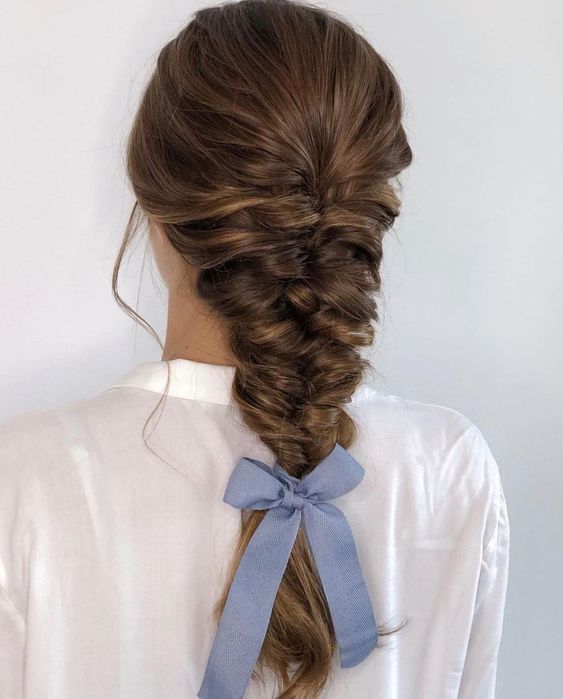 a volumetric wrapped braid with a volume on top and a small and cute blue bow for an accent