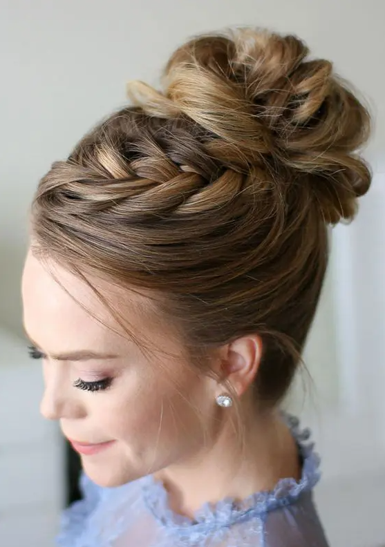 a wavy top knot with a braid on top is ideal to spruce up a traditional bun