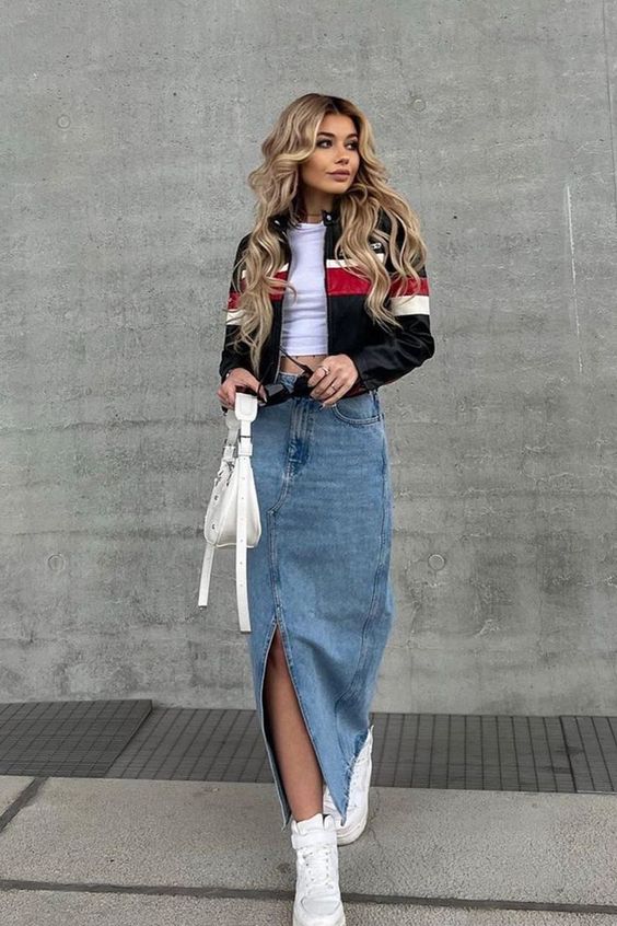 a white crop top, a blue denim maxi skirt, white high top sneakers, a white bag and a striped jacket for spring