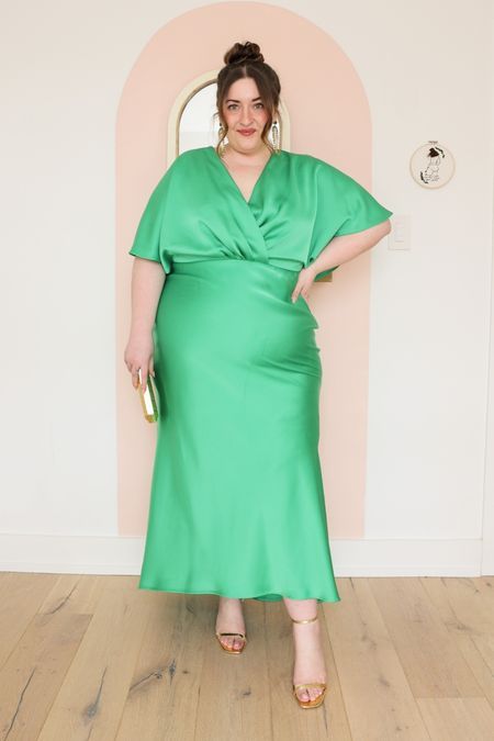 An apple green plain maxi dress with a V neckline and short sleeves, gold shoes and a small gold clutch