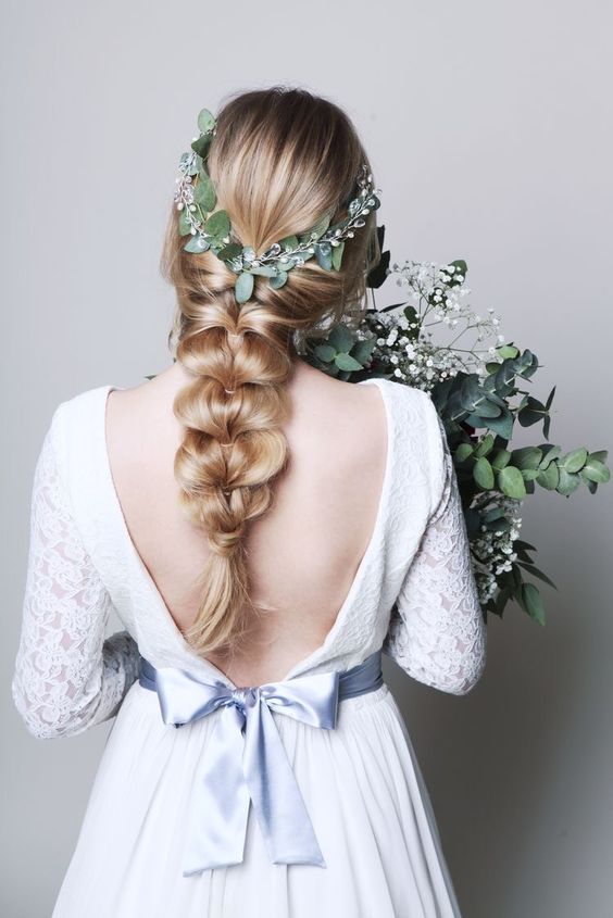 an elegant loose braid with a greenery hair vine is a lovely and catchy idea to rock at a wedding
