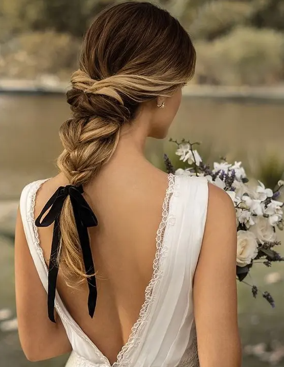 an elegant twisted braid with wavy ends and a black ribbon for an accent – it’s a hot and trendy idea
