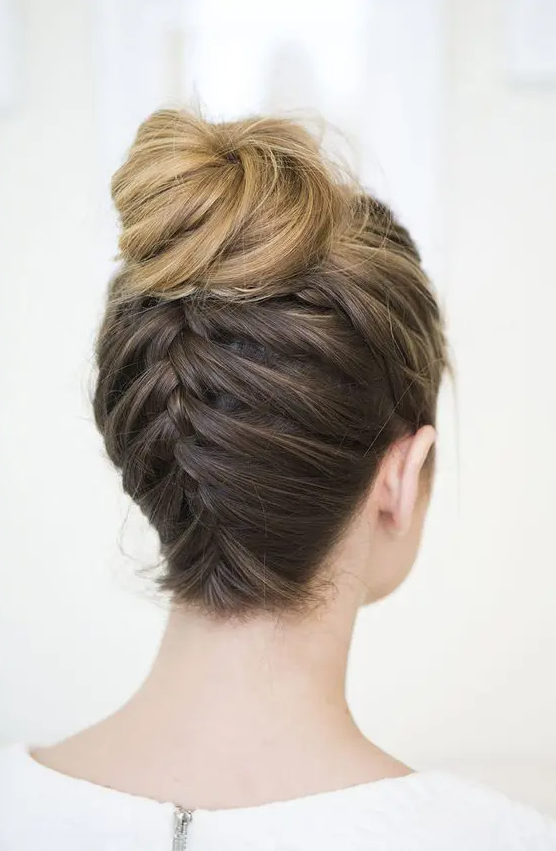 an upside down braided top knot is a cool solution for a glam boho bride, it looks veru unusual
