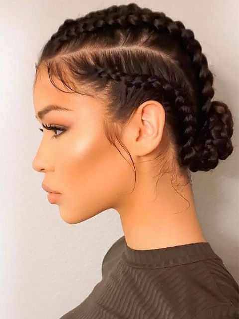 braids coming along the head and fixed in a low bun are a super chic and cool hairstyle not only for the gym