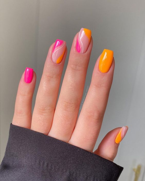 bright orange and hot pink nails with swirls are amazing for bold and eye-catchy summer looks