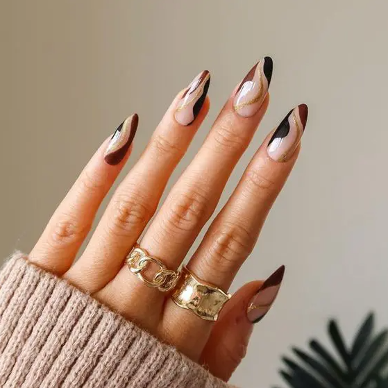 Colorful swirl almond shaped nails in black, burgundy and gold glitter are fantastic for fall or winter
